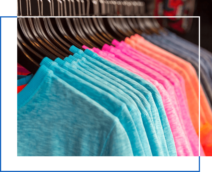 A rack of different colored shirts hanging on the side.