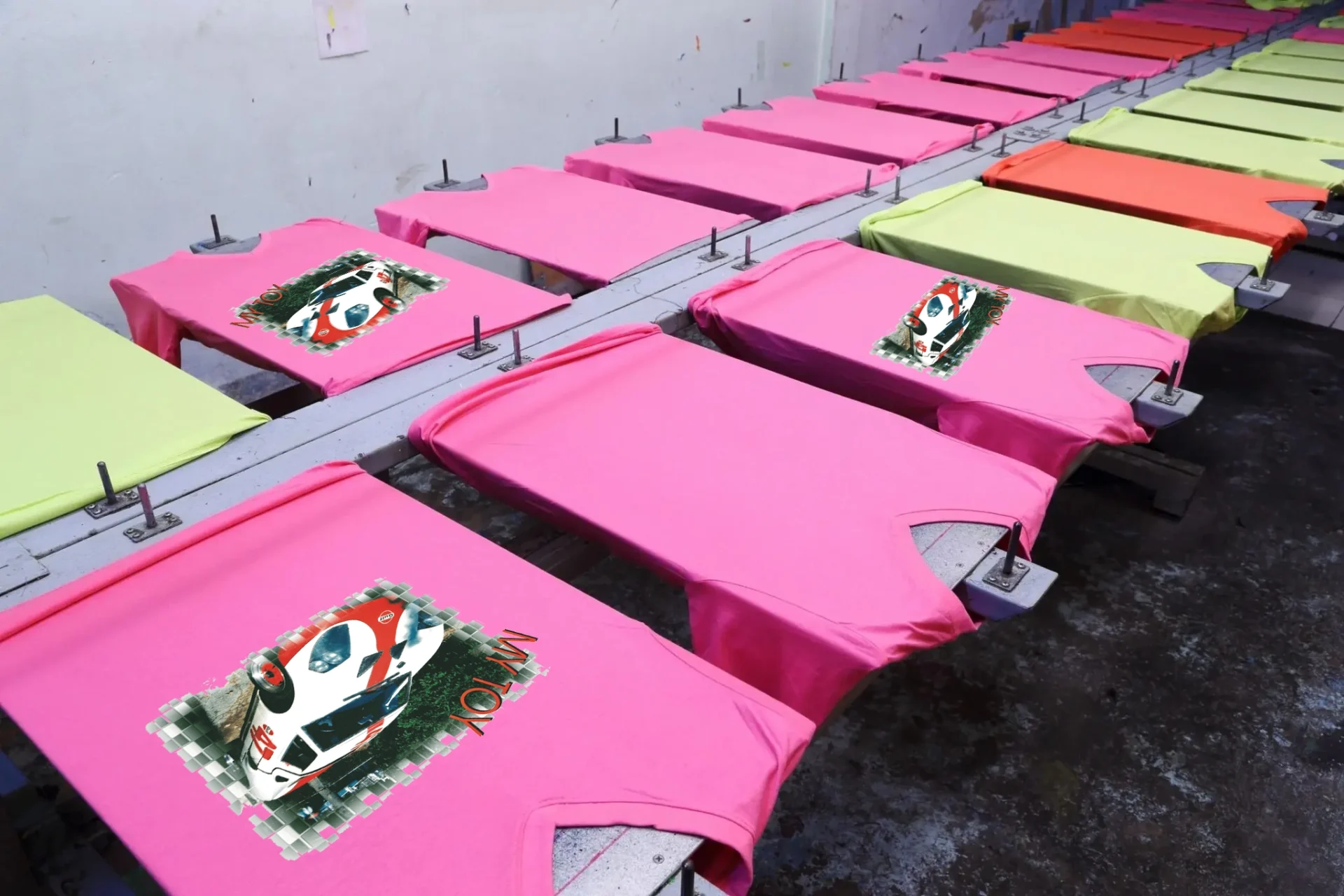 A row of cakes on top of pink sheets.